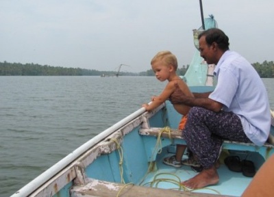 Бэквотерс, капитан лодки держит малыша. Керала