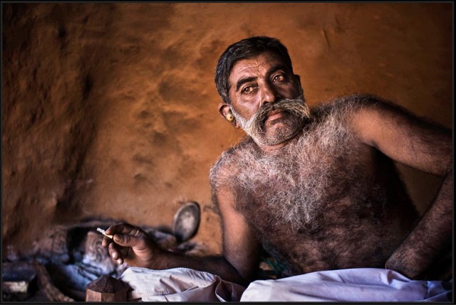 Rabari businessman relaxes with a cigarette - Barda Hills, Gujarat.
