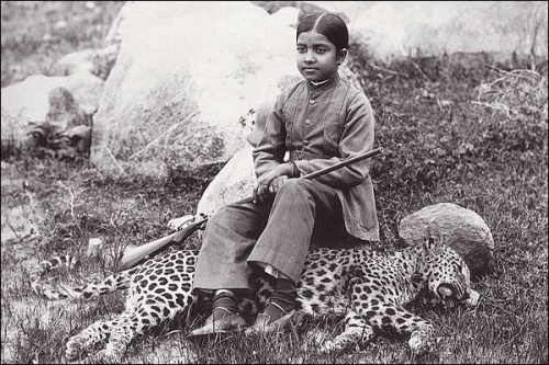 The daughter of an Indian maharajah seated on a panther she shot, sometime during 1920s.